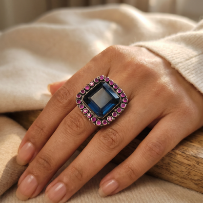 The Main Character — Blue Topaz & Ruby Cocktail Ring in Oxidised Silver