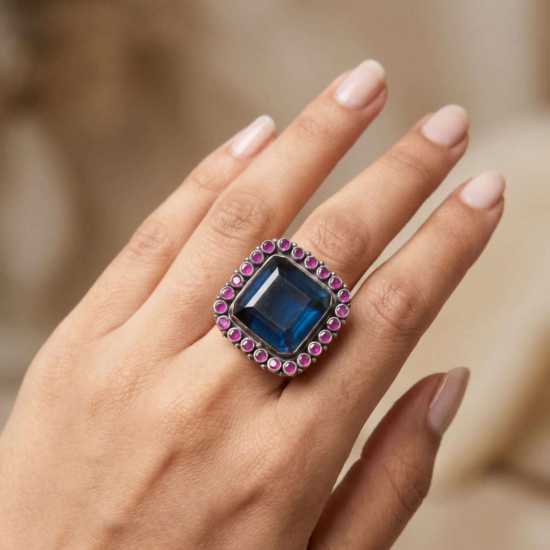 The Main Character — Blue Topaz & Ruby Cocktail Ring in Oxidised Silver
