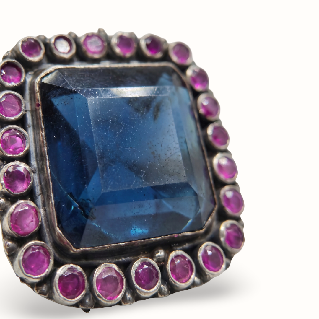 The Main Character — Blue Topaz & Ruby Cocktail Ring in Oxidised Silver